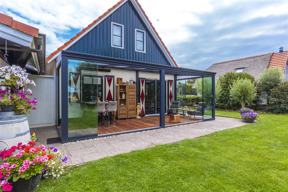 Large glass veranda across the full rear of a detached house